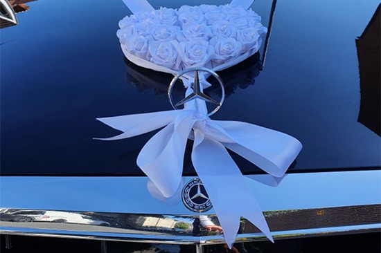 A Mercedes benz salon car decorated with ribbons for a wedding service in Southampton, UK.